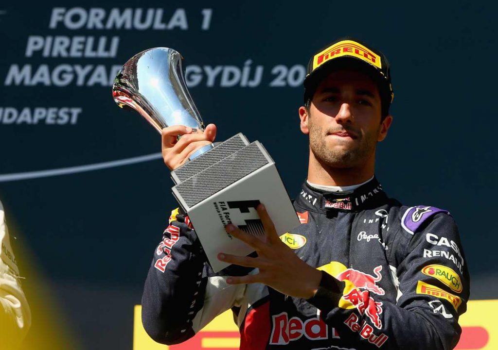 BUDAPEST, HUNGARY - JULY 26: Daniel Ricciardo of Australia and Infiniti Red Bull Racing celebrates with the trophy on the podium after finsihing third during the Formula One Grand Prix of Hungary at Hungaroring on July 26, 2015 in Budapest, Hungary. (Photo by Clive Mason/Getty Images)