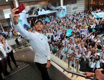 Lewis celebrates the championships with his colleagues at Petronas